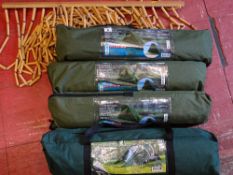 Parcel of three small fishing tents in canvas bags, a three person tent in a canvas bag and a wooden