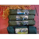 Parcel of three small fishing tents in canvas bags, a three person tent in a canvas bag and a wooden