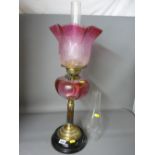 Victorian brass reeded column oil lamp with cranberry tinted glass reservoir and etched shade