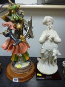 Continental figurine of a warrior and a G Armani composite figure of a gamekeeper