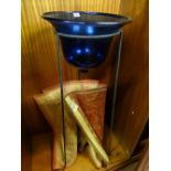 Deep Bristol blue glass basin on a tripod metal high stand and an oblong Laura Ashley rug in