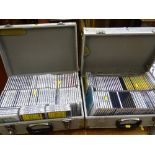 Two metal cases filled with a quantity of Karaoke CDs