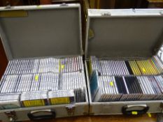 Two metal cases filled with a quantity of Karaoke CDs