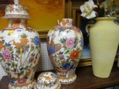 Pair of elaborately decorated vases A/F and another tall vase with dried flowers contents