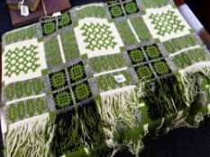 A green, cream & black geometric patterned Welsh woollen blanket