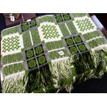 A green, cream & black geometric patterned Welsh woollen blanket