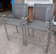 A pair of modern metal garden high chairs (outside)