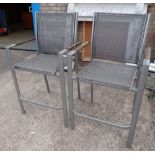 A pair of modern metal garden high chairs (outside)