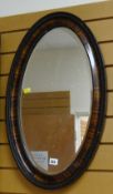 A good vintage oval mahogany framed bevel wall mirror