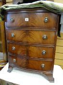 A small reproduction bow front chest of four drawers