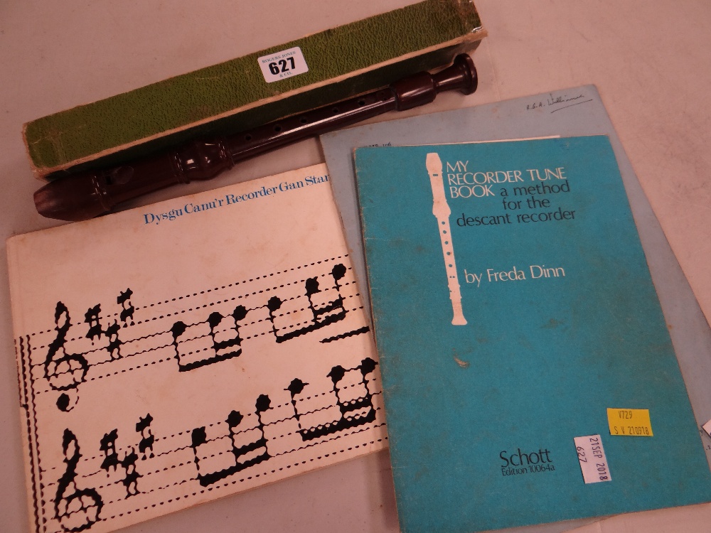 A vintage Dolmetsch recorder together with some recorder music books