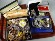 A large quantity of costume jewellery including brooches, boxed pens, spoons, Swarovski brooches (