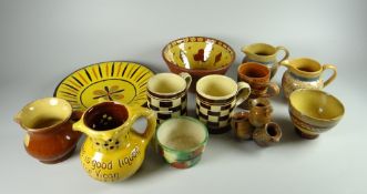 A tray of various patterned slipware pottery