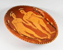 A twentieth century slipware oval dish decorated with two lined figures and in raised lettering '