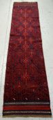 A patterned blue & red ground Meshwani runner, 256 x 63cms