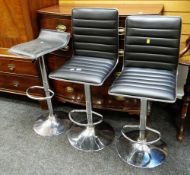 A pair of modern chrome based bar stools & another