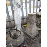 Composite stone ornamental sun dial on stand together with a similar garden statue (outside)