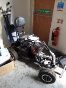An electric golf buggy with clubs & equipment etc