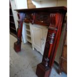 A carved mahogany fire surround