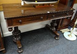 An antique mahogany two-drawer side table