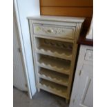 A painted French-style wine rack with drawer