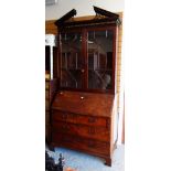 An antique mahogany bureau bookcase