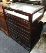 A good bijouterie / specimen table with a bank of six drawers, base cupboard & drop flap glass upper