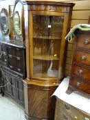 A reproduction standing corner cabinet