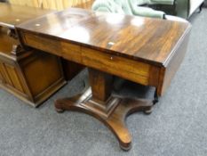 An antique rosewood drop flap sofa table with drawers