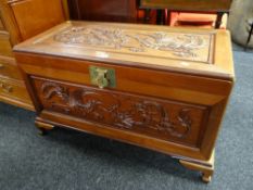 An Oriental carved camphor wood blanket chest