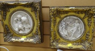 A pair of reproduction gilt framed relief plaques