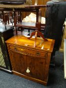 A reproduction mahogany effect closed bookcase with upper drawer, a Long John coffee table &
