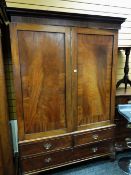 An antique mahogany press cupboard with a base of one long & two short drawers on bracket feet