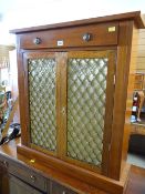 A mahogany pier cabinet with fabric in grill frontage & single drawer
