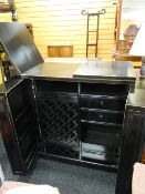 A modern Oriental black lacquer-type foldout drinks cabinet / bar
