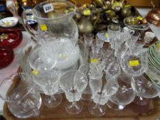 A tray of glassware including cut glass jug, drinking glasses etc