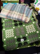 A green & black geometric design Welsh blanket together with a smaller woollen check blanket