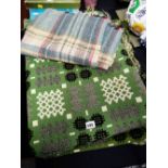 A green & black geometric design Welsh blanket together with a smaller woollen check blanket