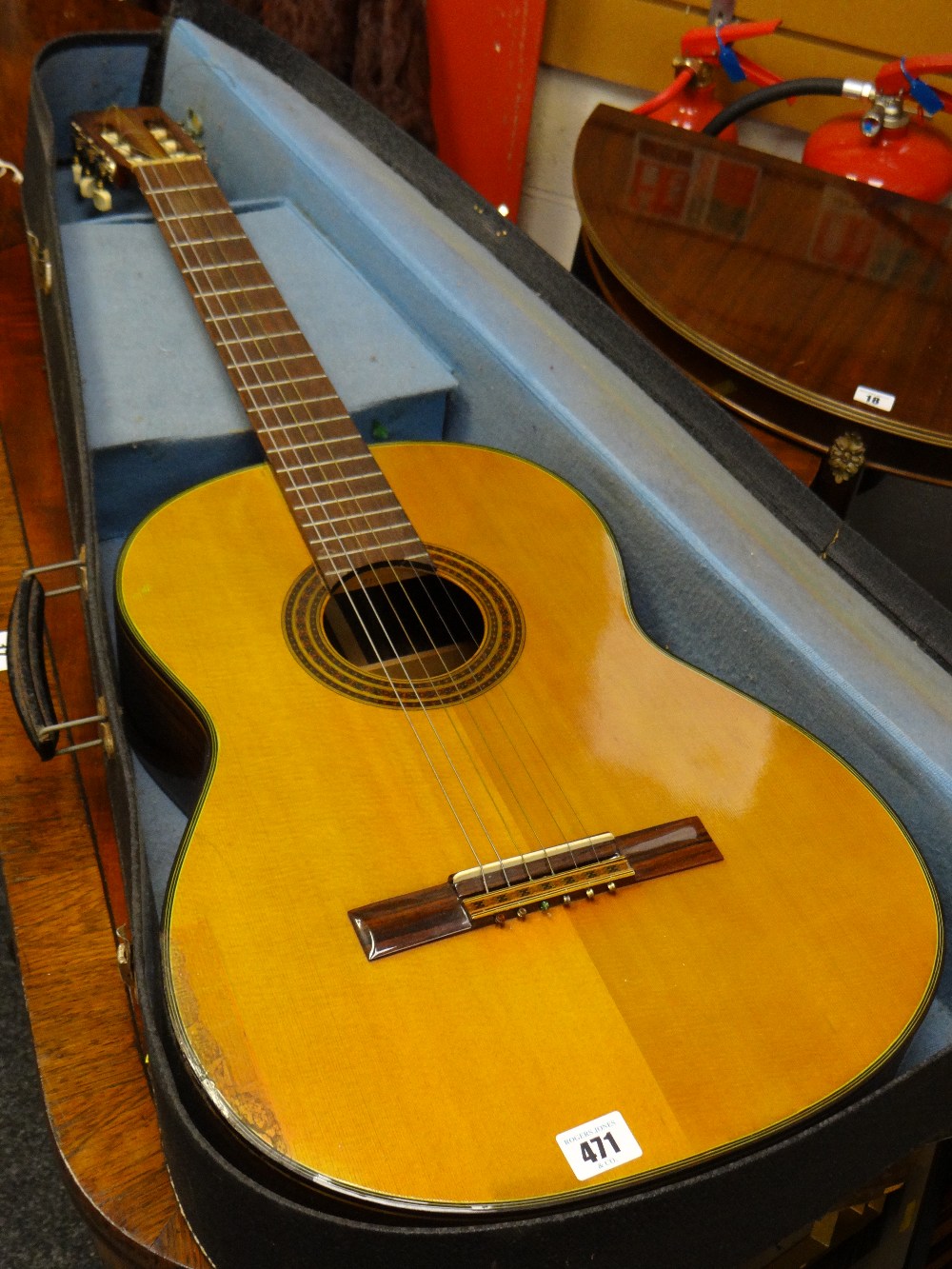 A cased Japanese acoustic guitar