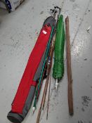 A carry bag containing quantity of fishing rods & equipment, fishing umbrella etc