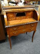 An excellent antique cylinder top writing desk with marquetry cover, two base drawers & yellow metal