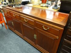 An Oriental hardwood sideboard with four drawers & two cupboards