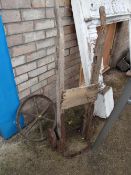 Decorative cast iron cart wheel together with a distressed sack truck (outside)