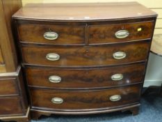 An antique bow front mahogany chest of three long & two short drawers