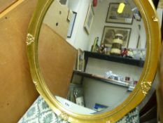 Gilt framed oval bevelled wall mirror