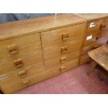 Pair of light wood seven drawer chests with wooden cup handles