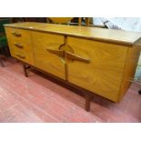Mid Century sideboard with three drawers and twin cupboards with interesting handles