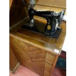 Singer manual sewing machine in cabinet