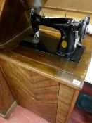 Singer manual sewing machine in cabinet