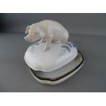 Royal Copenhagen porcelain box and cover formed as a seated pig, the base and lid rim banded in